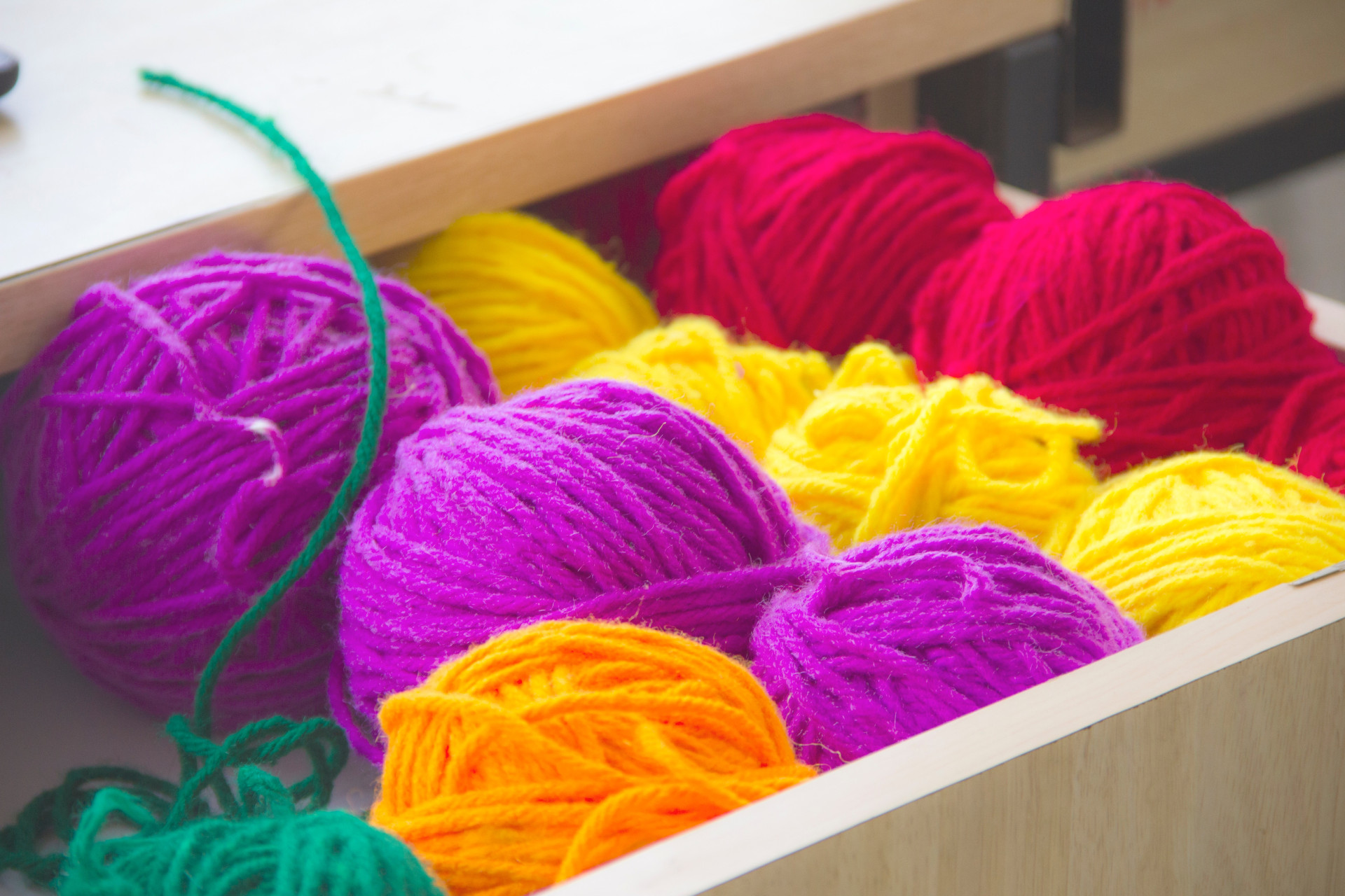 An image of multicoloured yarns in a drawer for wholesale